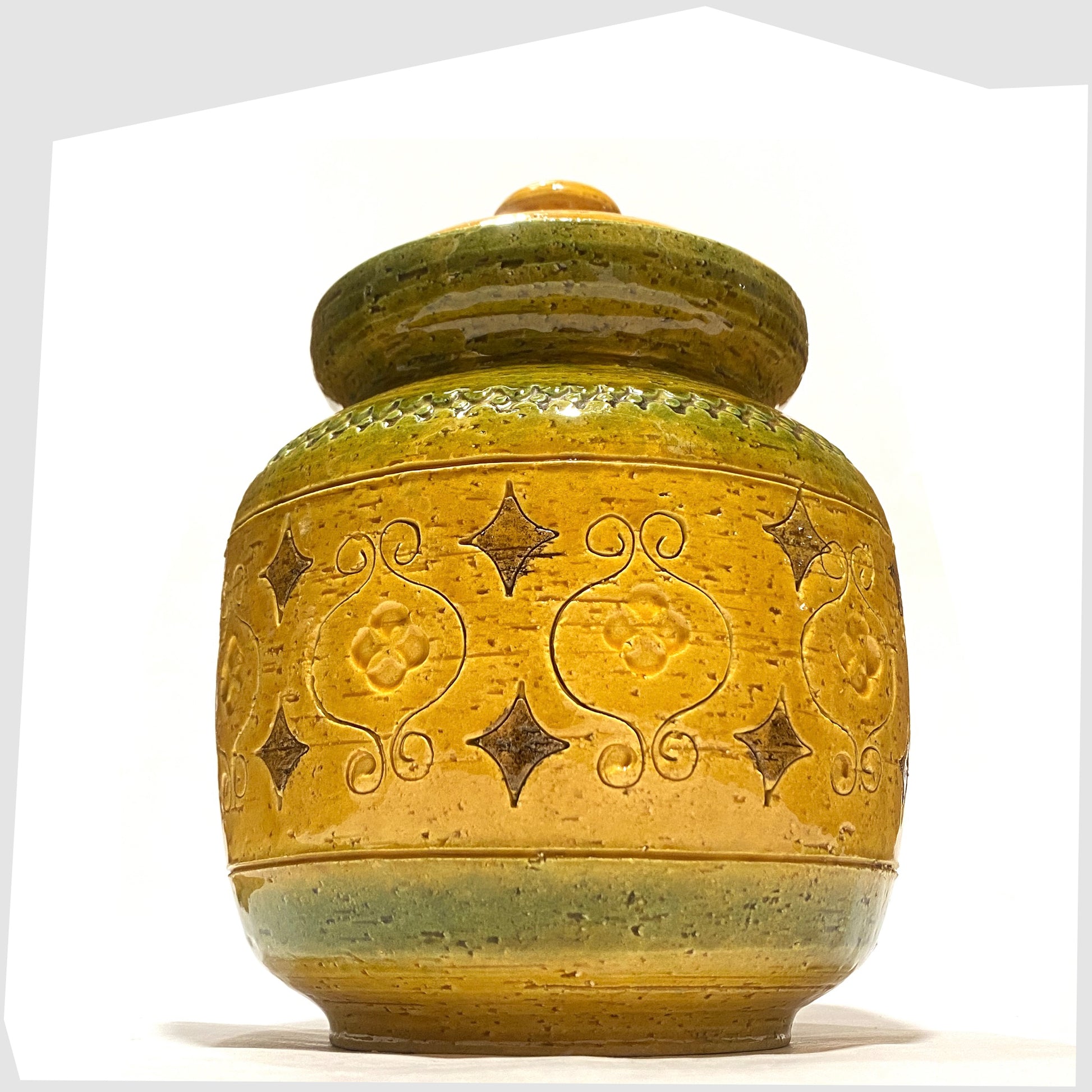 Bitossi Ceramiche Arabesque Lidded Jar in yellow glaze with green bands and impressed markings, shown on a white background