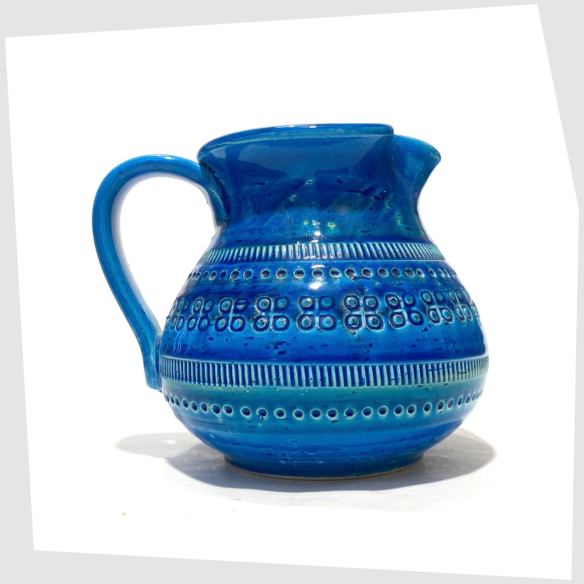 Flavia Montelupo/Bitossi Vase with looped handle and pinched spout in iconic blue glaze with impressed markings, shown on a white background