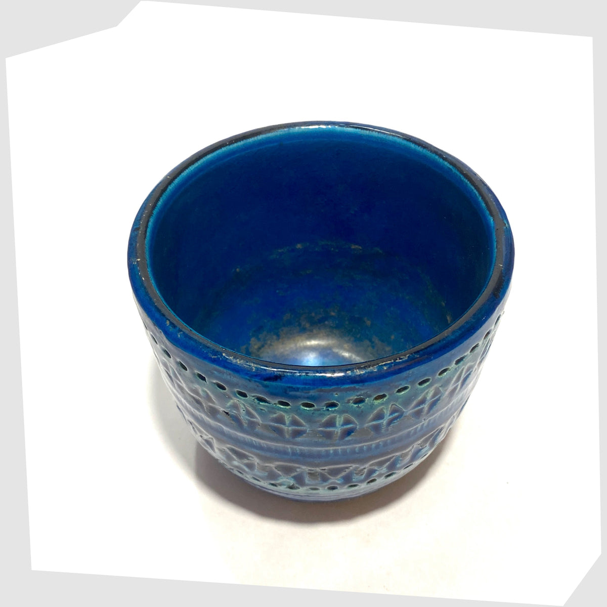 top rim and inner glaze of the Bitossi Rimini Blue Planter designed by Aldo Londi in a rich blue glaze with an array of impressed markings, shown on a white background