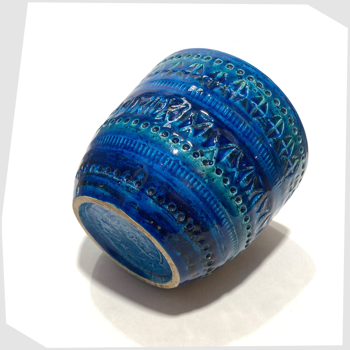 Side of the Bitossi Rimini Blue Planter designed by Aldo Londi in a rich blue glaze with an array of impressed markings, shown on a white background