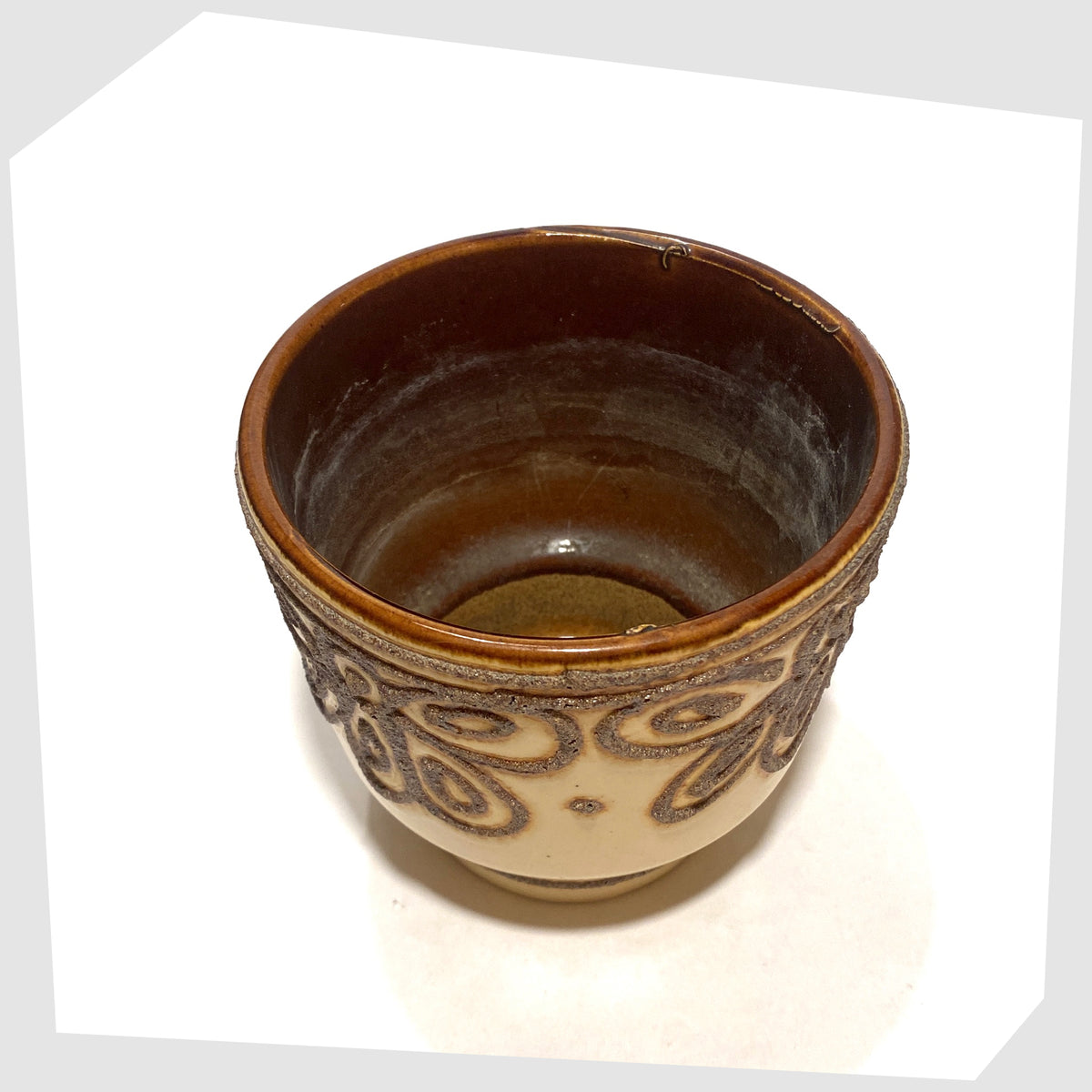 Inside of the B.P.F. Heffen Planter in a matte beige glaze with brown fat lava design, shown on a white background