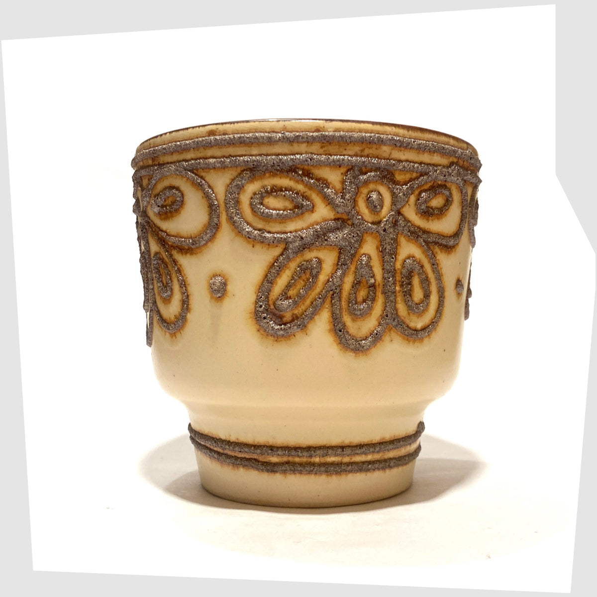 B.P.F. Heffen Planter in a matte beige glaze with brown fat lava design, shown on a white background