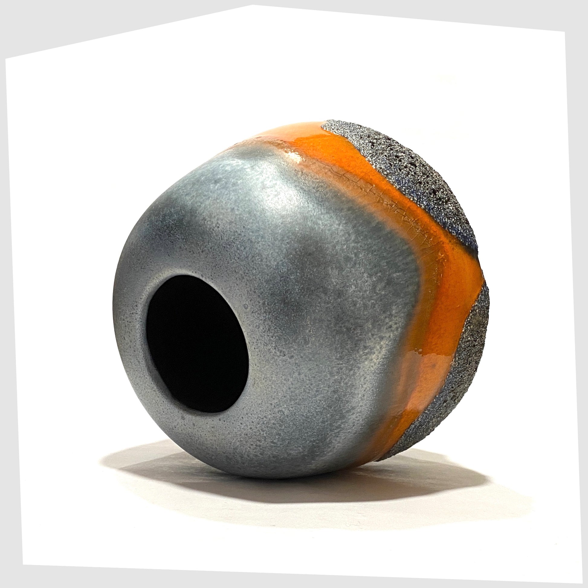 Top opening of the Carsten Tonnieshof Vase in asteroid form with bands of cool grey, volcanic orange and blue fat lava