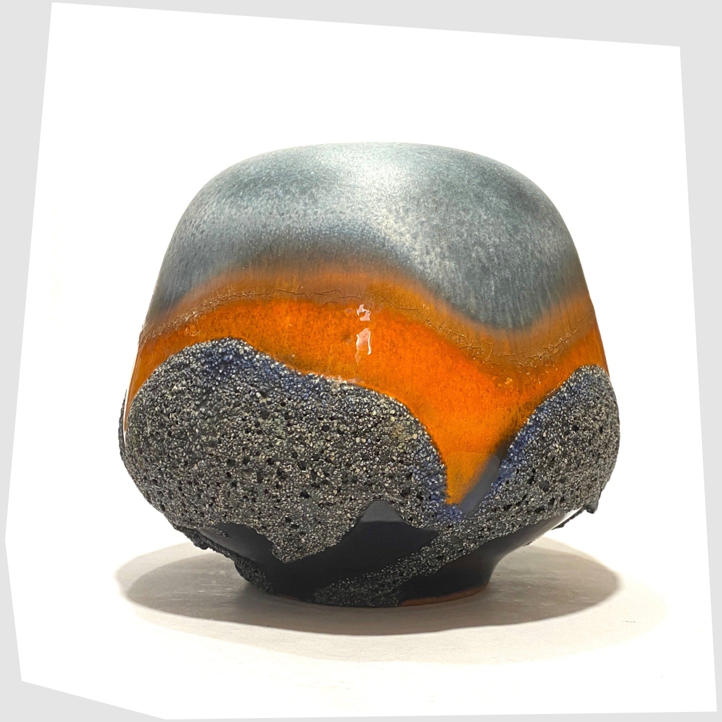 1970s Carsten Tonnieshof Vase in asteroid form with bands of cool grey, volcanic orange and blue fat lava