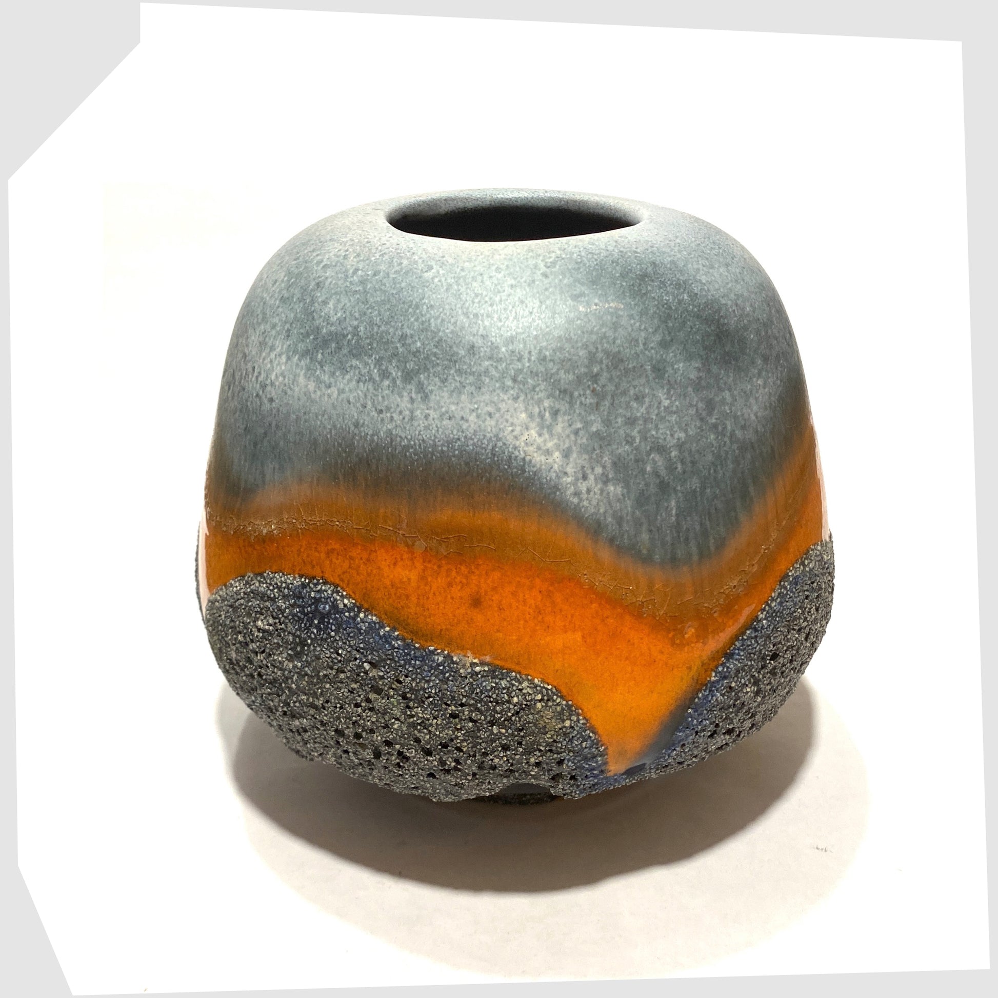 Top rim of the Carsten Tonnieshof Vase in asteroid form with bands of cool grey, volcanic orange and blue fat lava