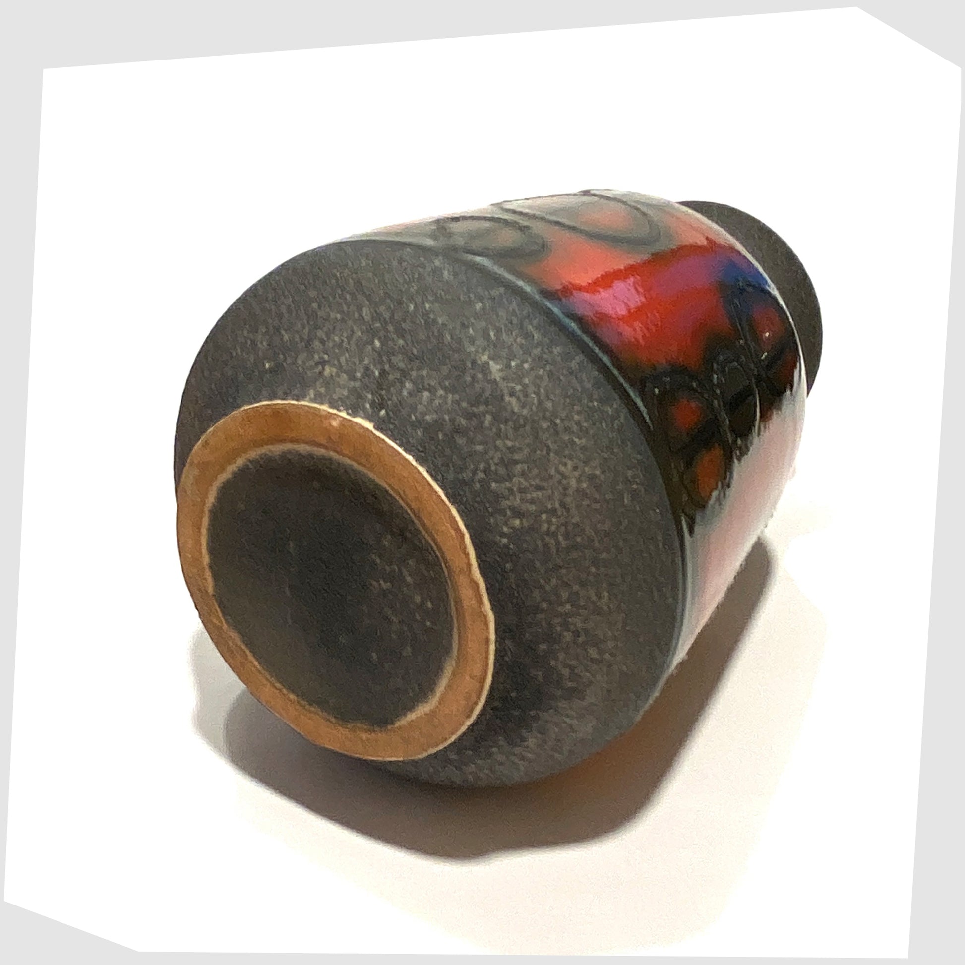 Base of the Carstens Tonnieshof Vase in matte grey glaze with a central band of red fat lava glaze