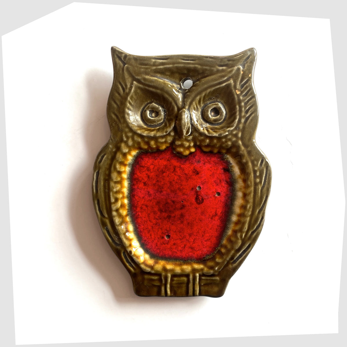 Mid-century ceramic owl shaped spoon rest with volcanic red glaze, shown on a white background