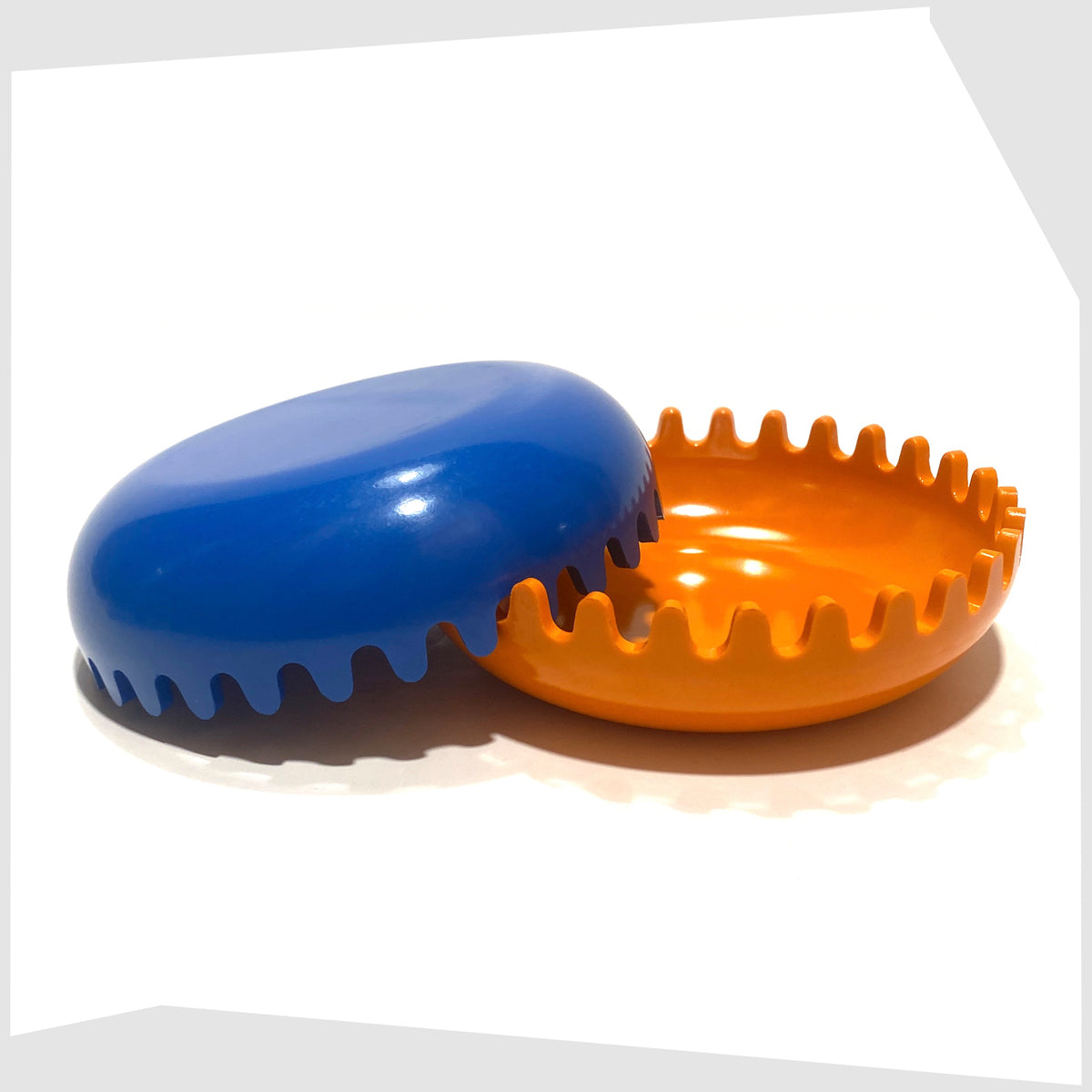 Vintage Clam Ashtray in Orange and Blue, designed by Alan Fletcher for Pentagram design in 1972, shown open on a white background