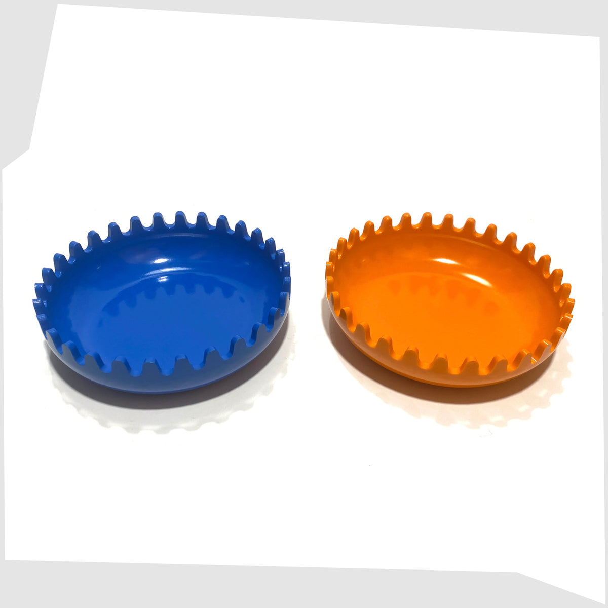Clam Ashtray in Orange and Blue, designed by Alan Fletcher for Pentagram design in 1972, shown apart on a white background