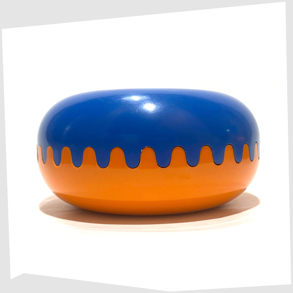 Vintage Clam Ashtray in Orange and Blue, designed by Alan Fletcher for Pentagram design in 1972, shown on a white background