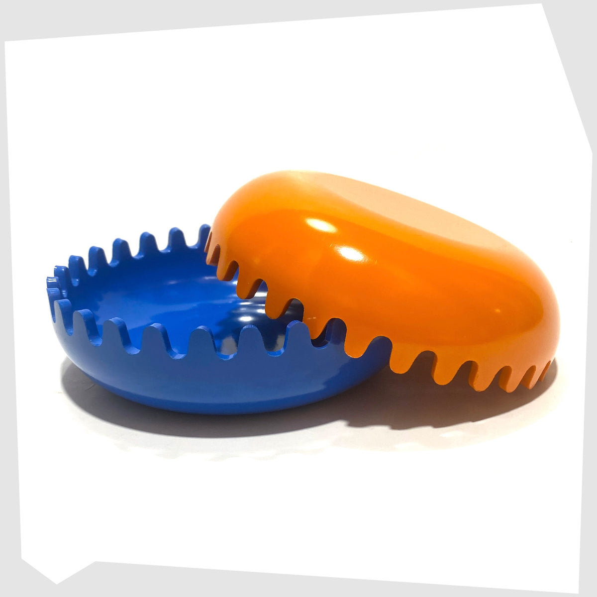 Clam Ashtray in Orange and Blue, designed by Alan Fletcher for Pentagram design in 1972, shown open on a white background