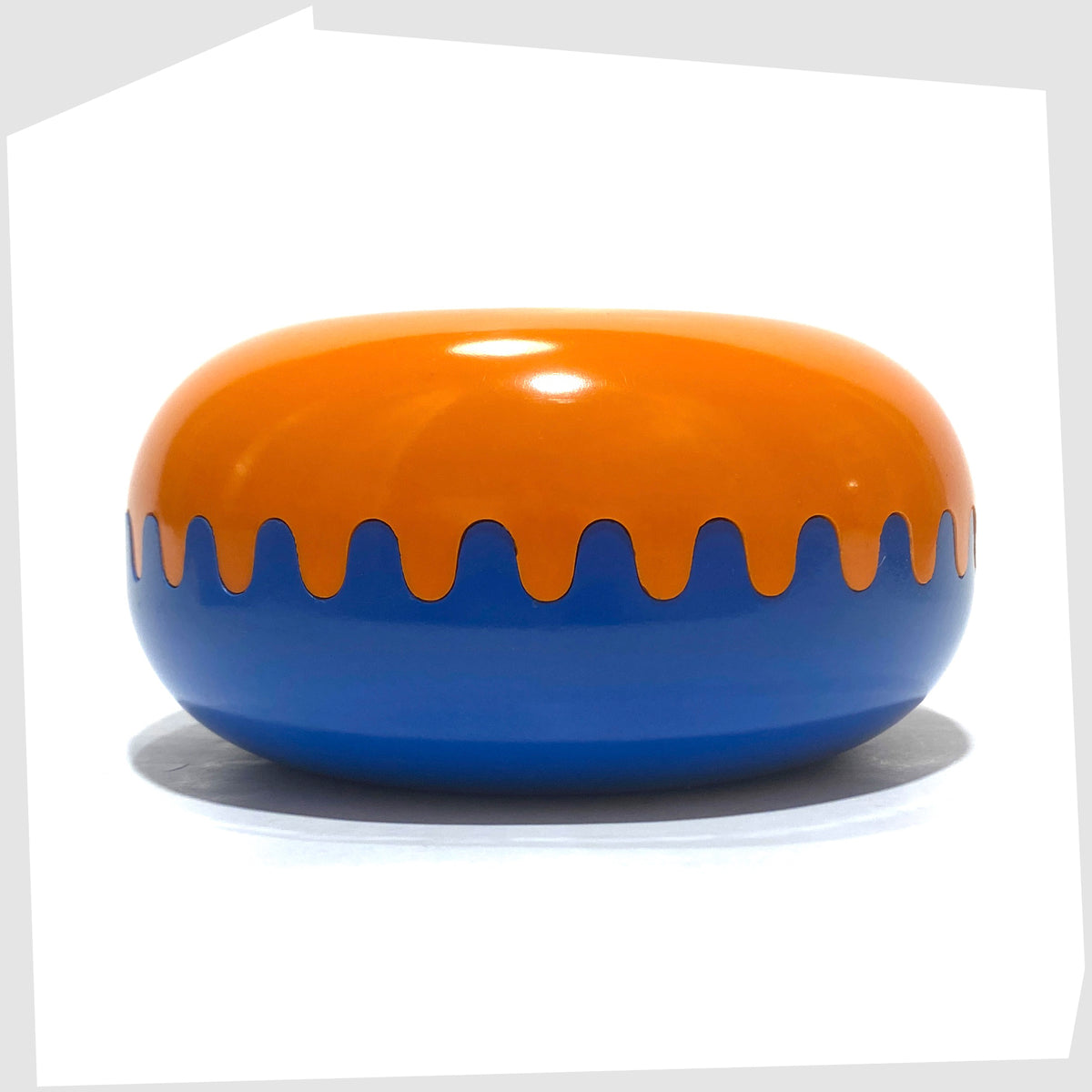 Clam Ashtray in Orange and Blue, designed by Alan Fletcher for Pentagram design in 1972, shown on a white background