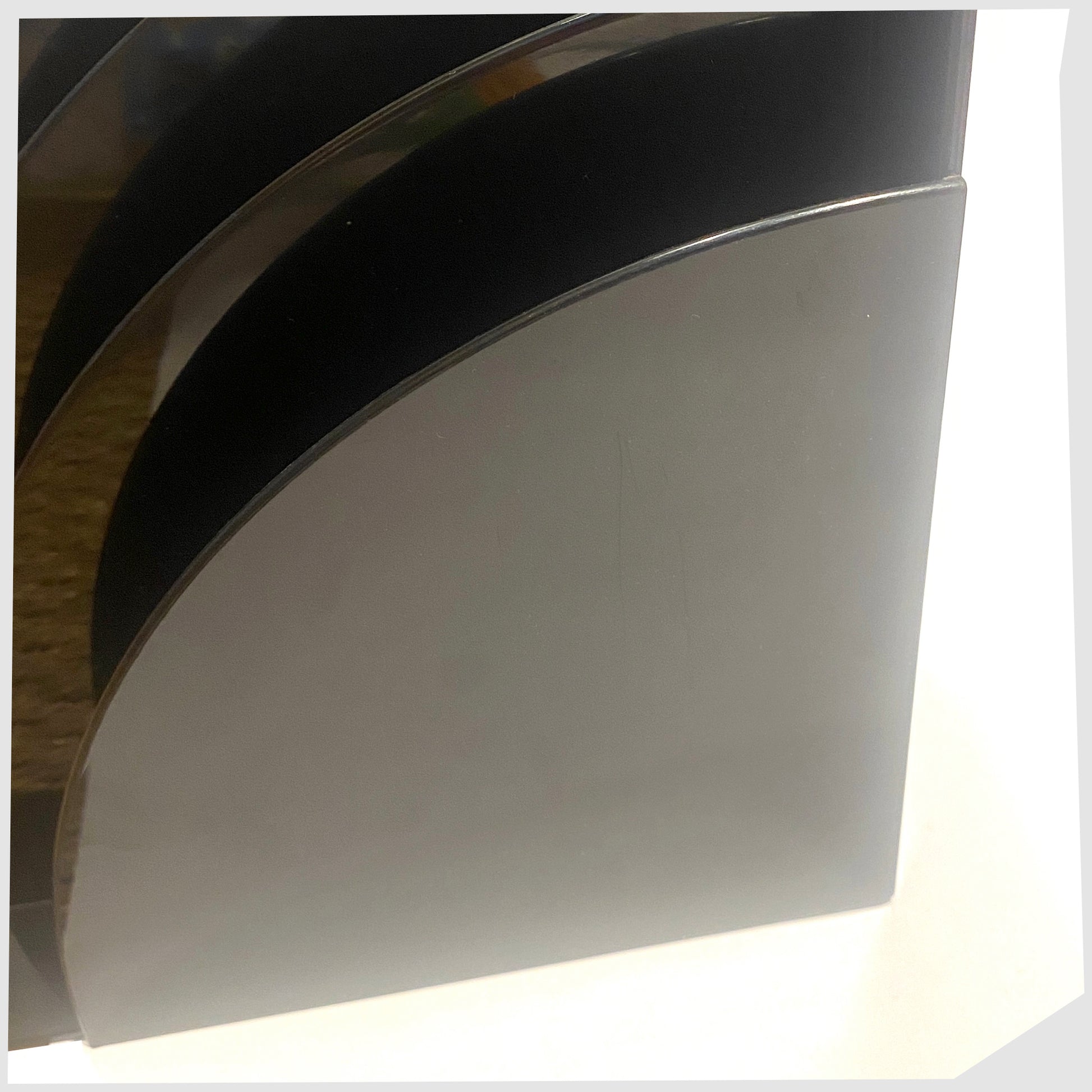 Close up of the Crayonne Record Rack in Black, designed by Terrance Conran for Habitat's 1970s plastic collection, shown on a white background