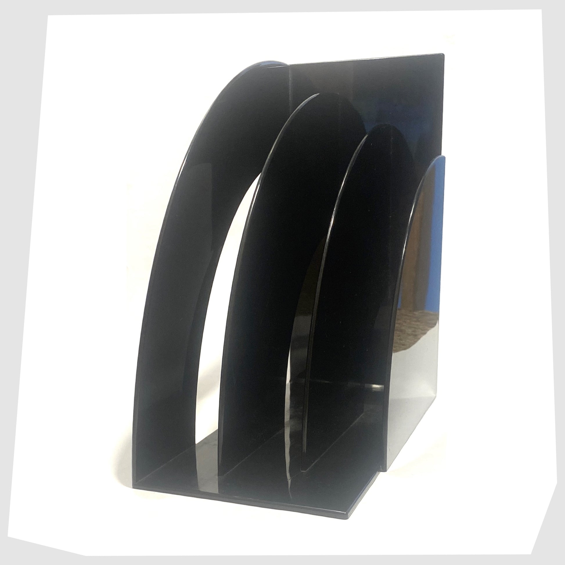 Side profile of the Crayonne Record Rack in Black, designed by Terrance Conran for Habitat's 1970s plastic collection, shown on a white background