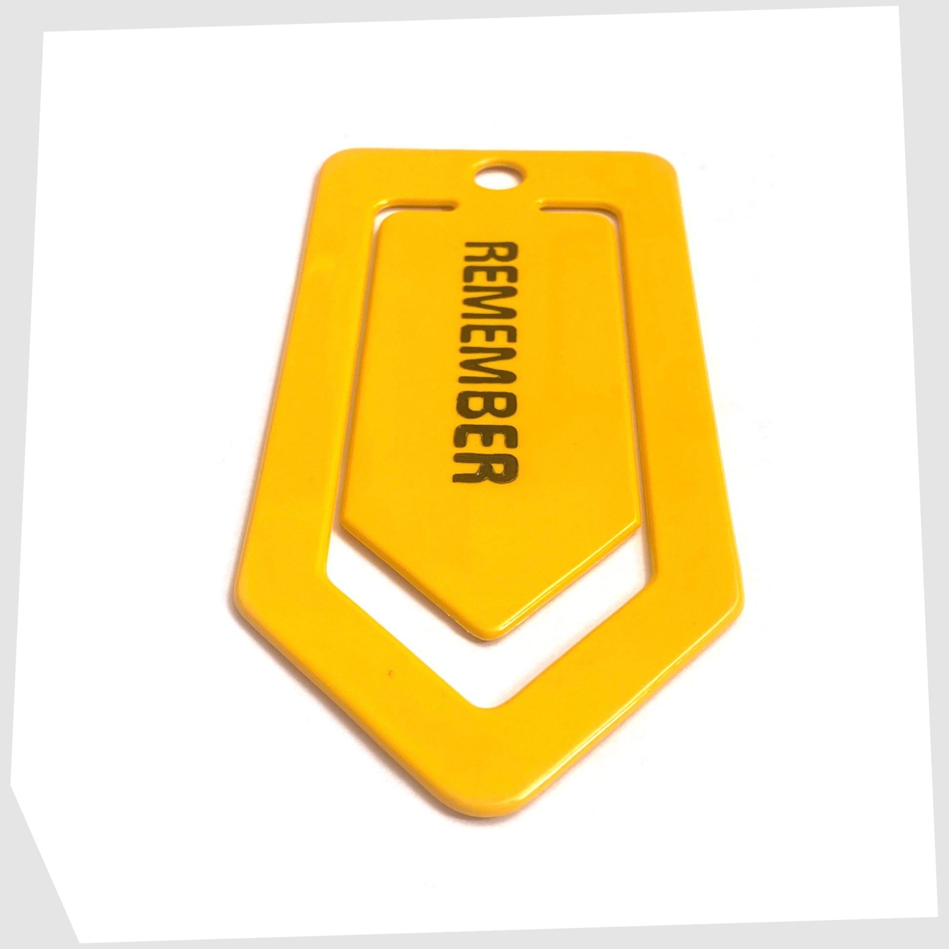 Crayonne Remember Paper Clip in mustard yellow with black text
