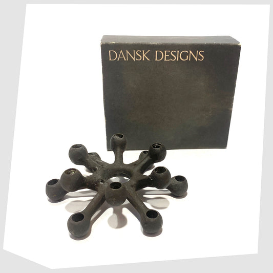 Danish Design Spider Candleholder in black cast iron, shown with its original box on a white background