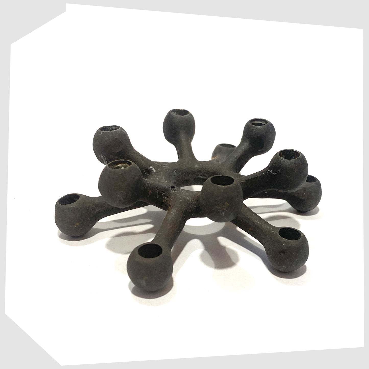 Danish Design Spider Candleholder made of black cast iron, shown on a white background