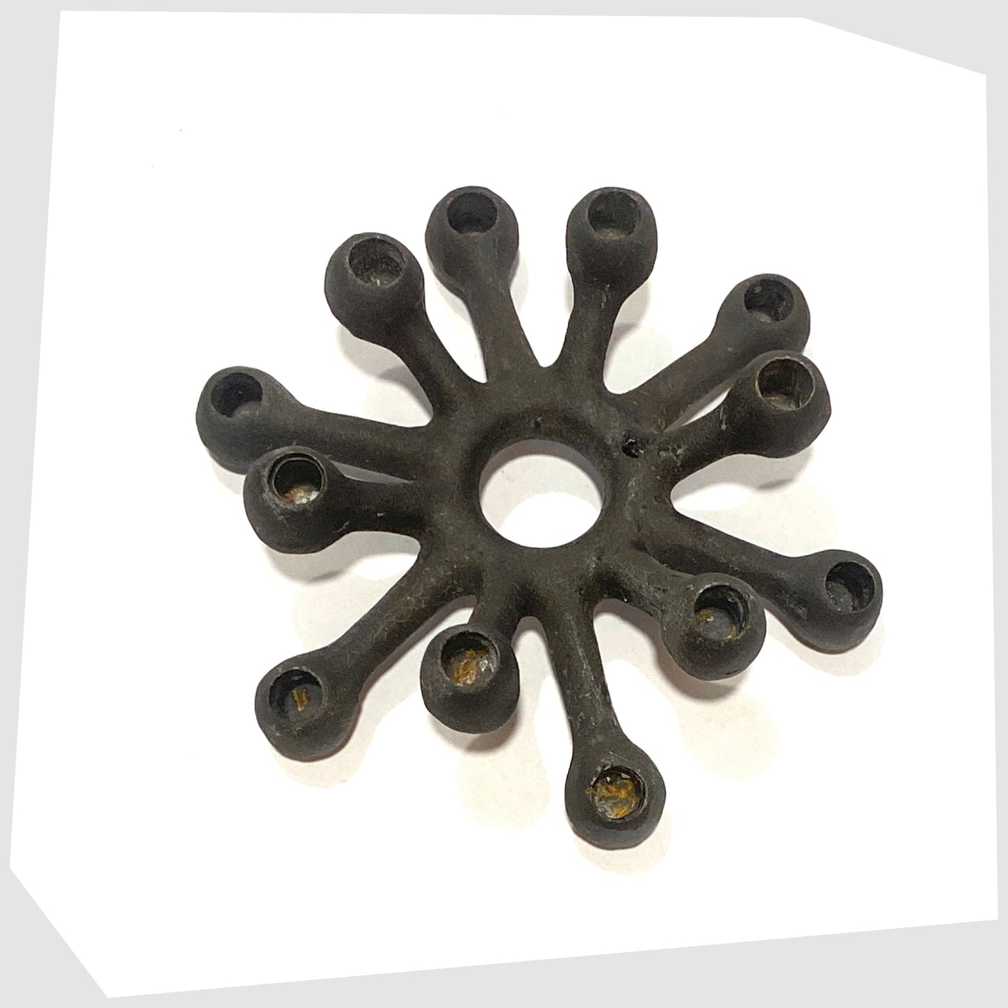 Danish Design Spider Candleholder in black cast iron on a white background