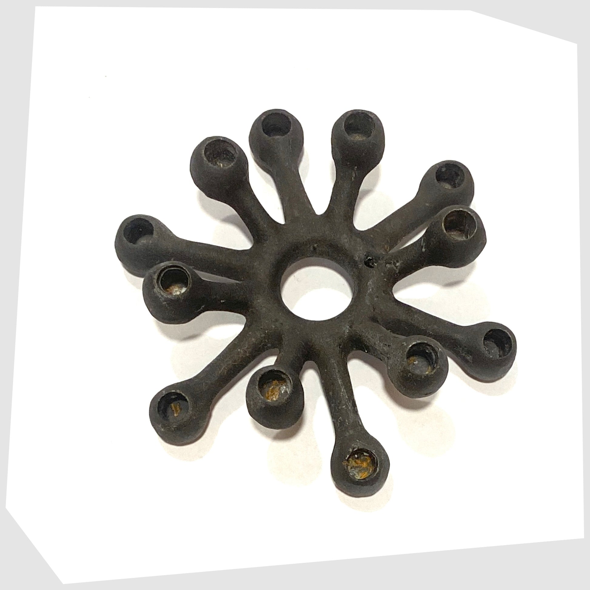 Danish Design Spider Candleholder in black cast iron on a white background