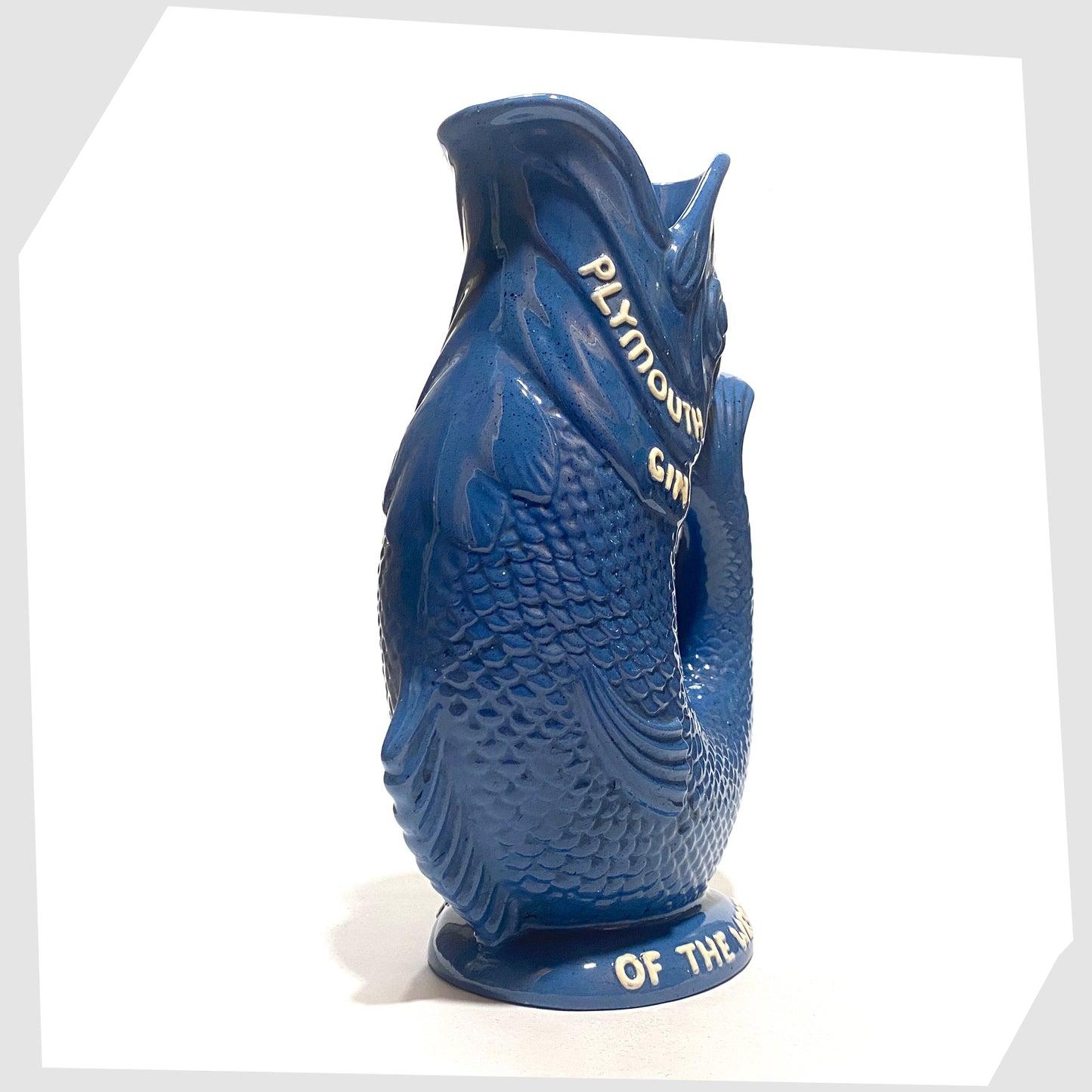 Front of the Dartmouth Pottery Plymouth Gin Gluggle in a sea blue glaze with white text around the spout and base