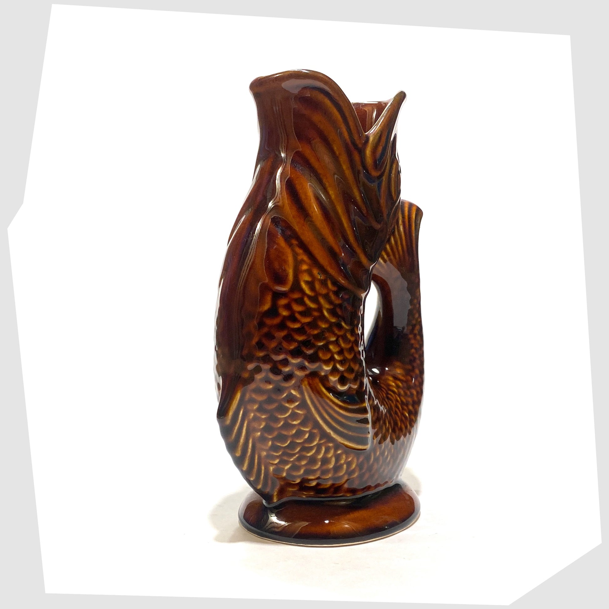 front of the Dartmouth Pottery Gluggle Jug in a rich chestnut brown glaze