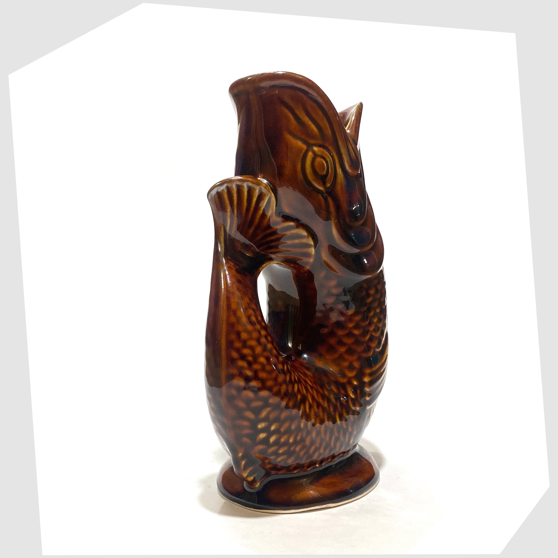 handle of the Dartmouth Pottery Gluggle Jug in a rich chestnut brown glaze