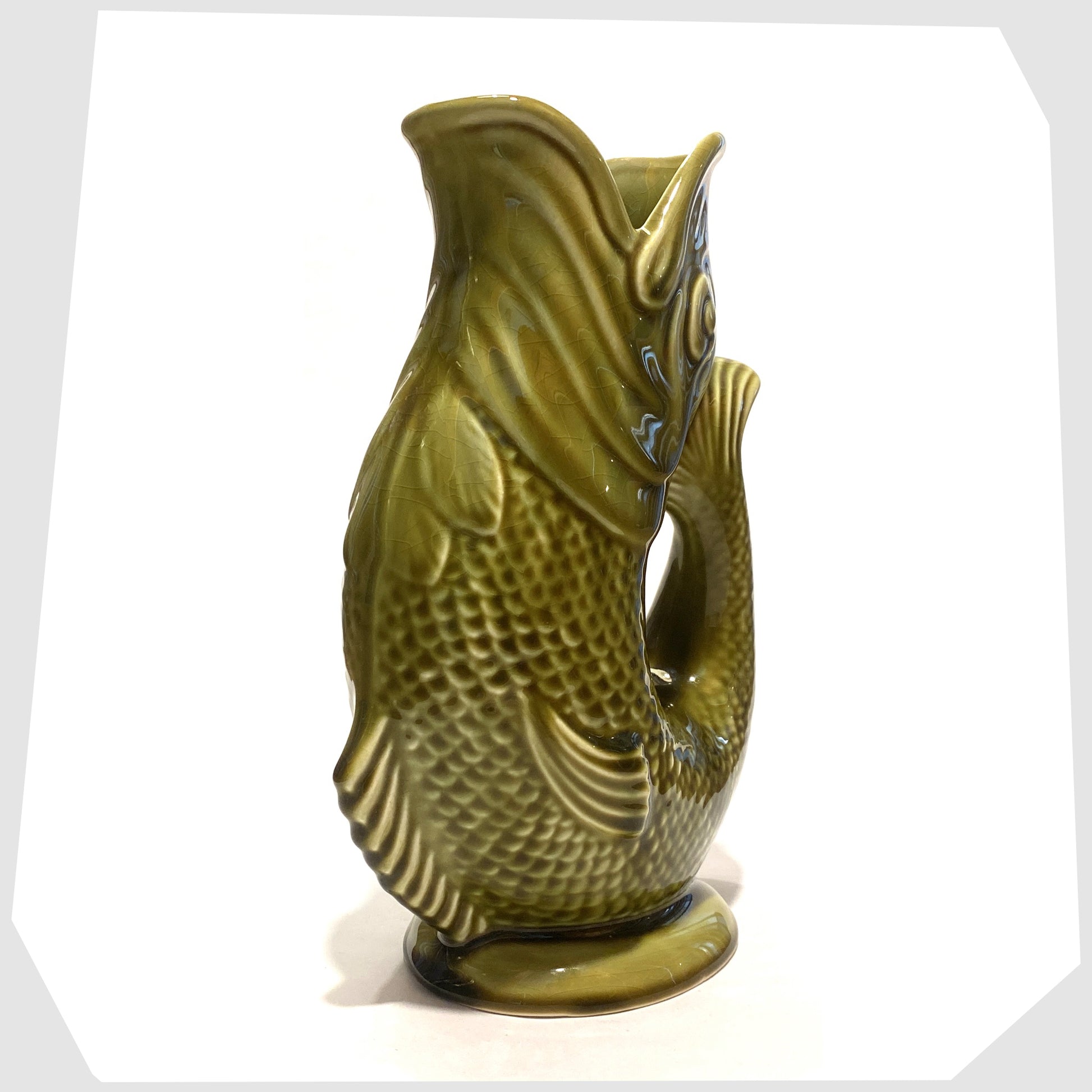 front of the Dartmouth Pottery Gluggle Jug in khaki green glaze