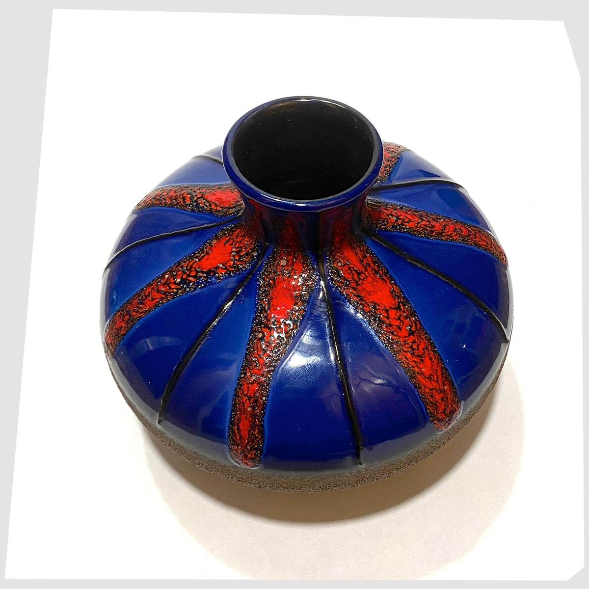 Top rim of the Dumler and Breiden Vase with a contrasting glaze of matte natural glaze and vivid blue and red fat lava, shown on a white background