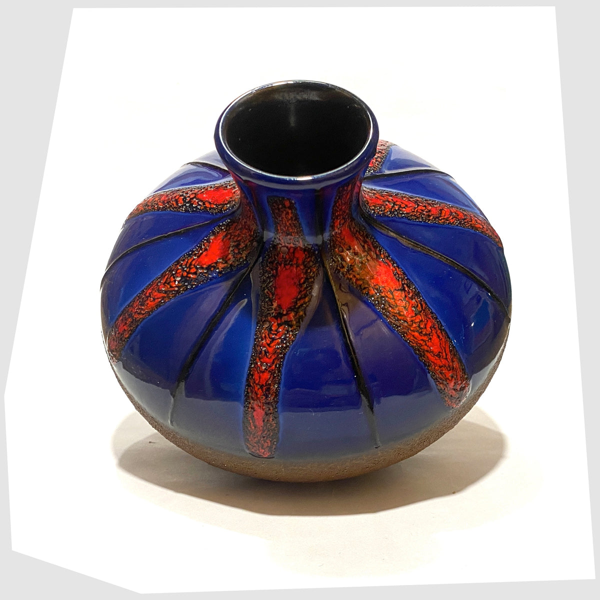 1970s West German Pottery Vase by Dumler and Breiden with a contrasting glaze of matte natural glaze and vivid blue and red fat lava, shown on a white background