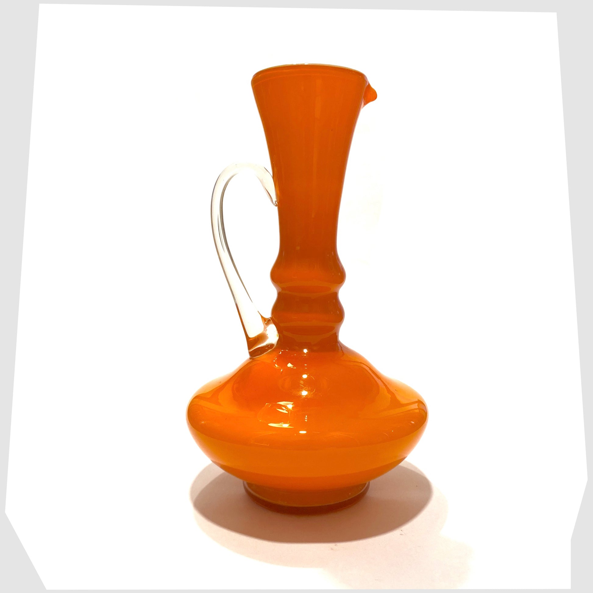 1960s vintage empoli glass jug in vibrant orange cased glass with clear glass handle
