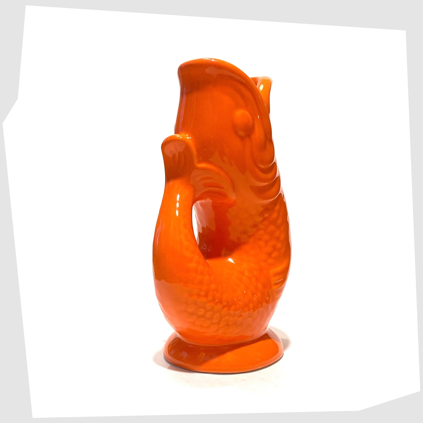 tail of the fish-shaped ceramic vase in bold orange glaze 