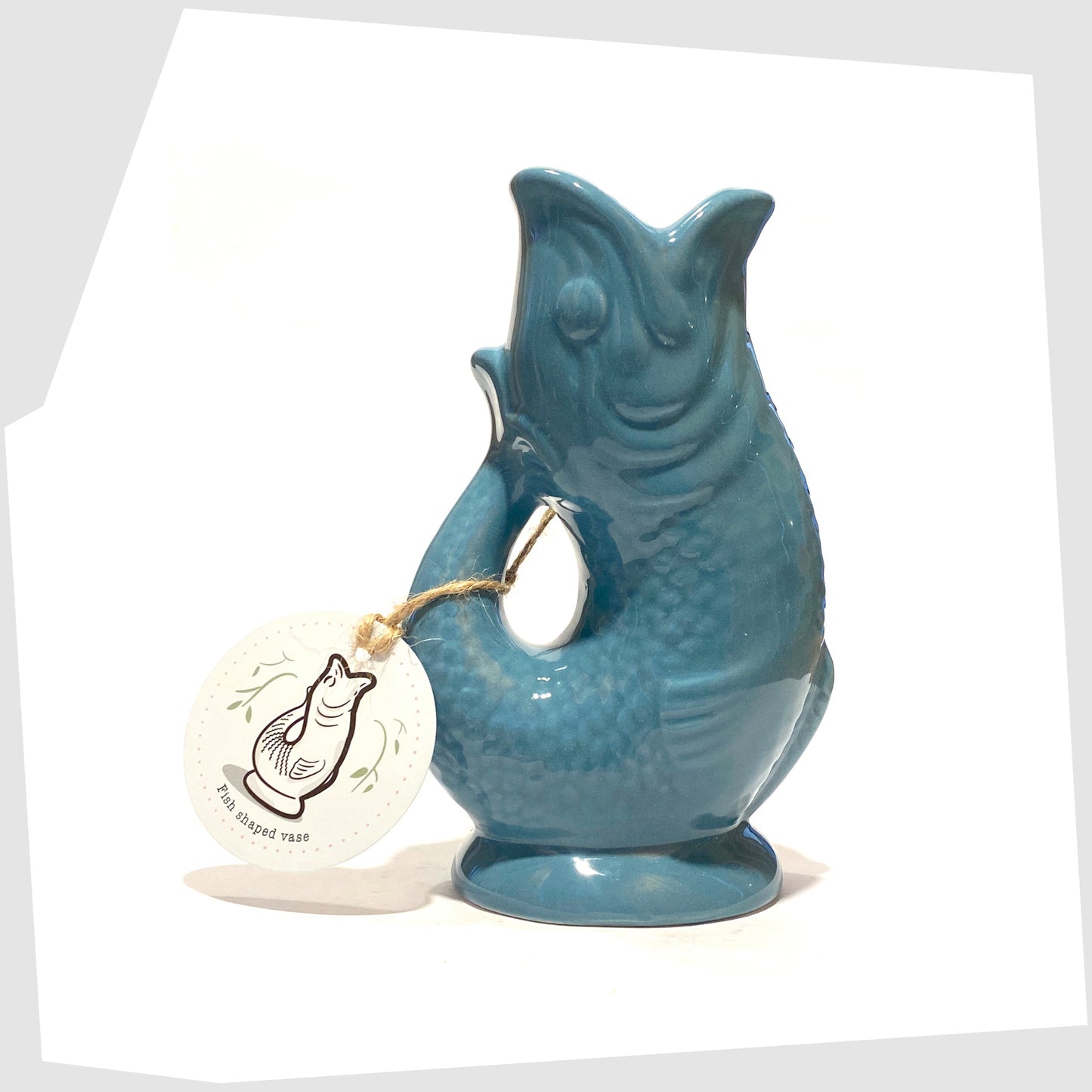 fish-shaped ceramic vase in blue shown with its printed card tag