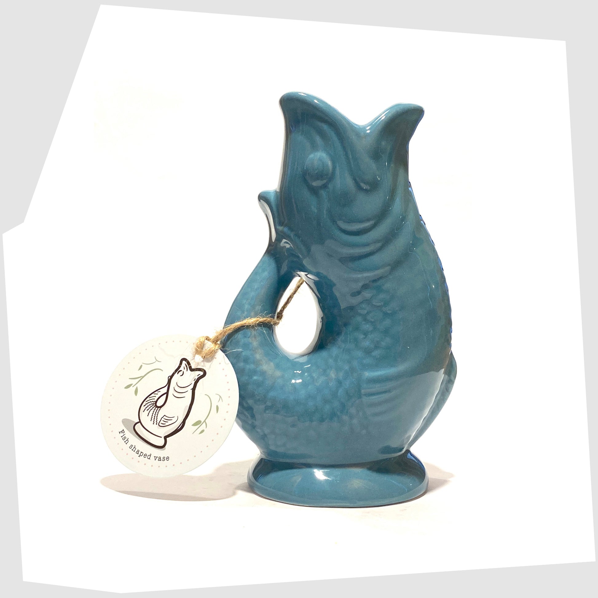fish-shaped ceramic vase in blue shown with its printed card tag