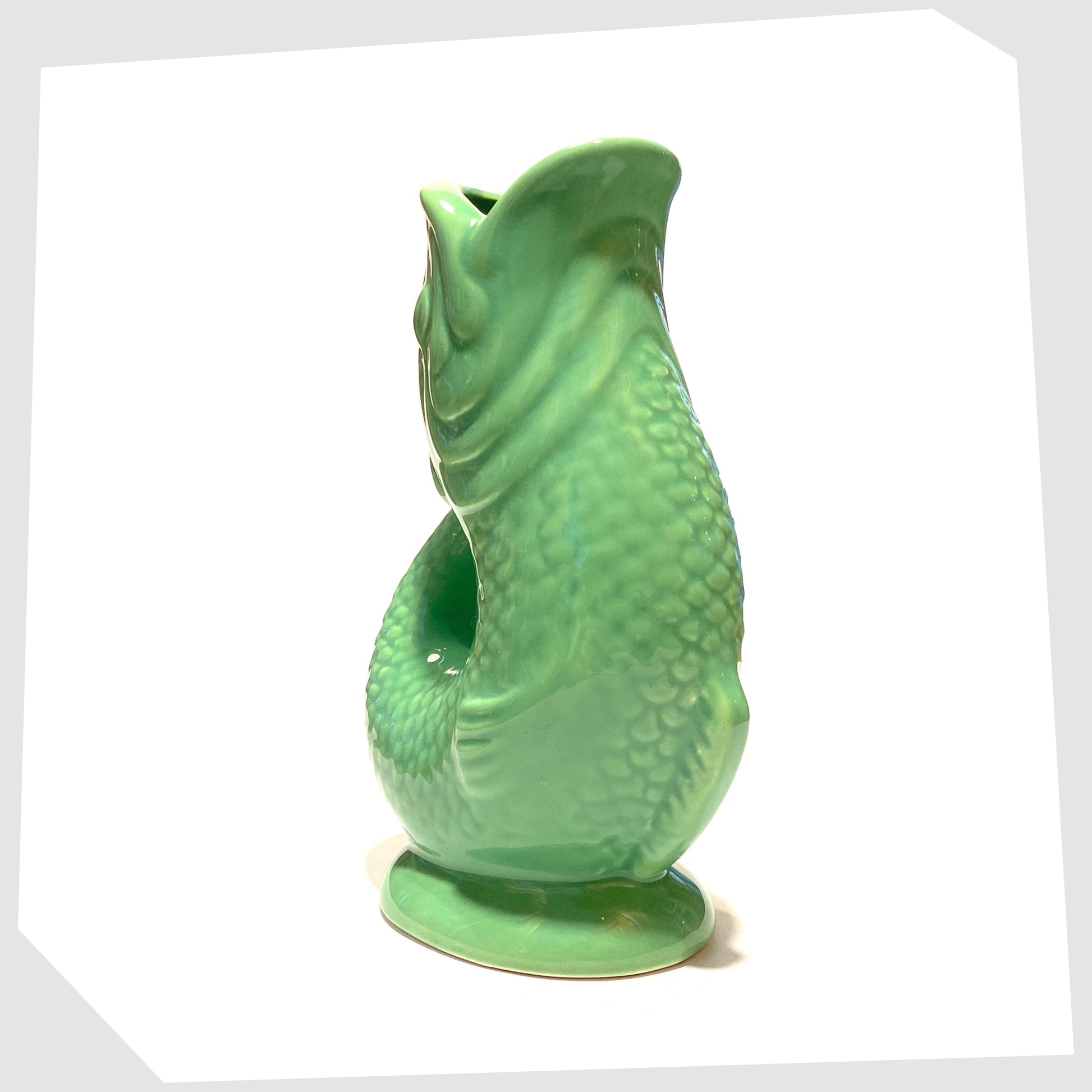 front of the Ceramic Fish-Shaped Vase in bold green glaze