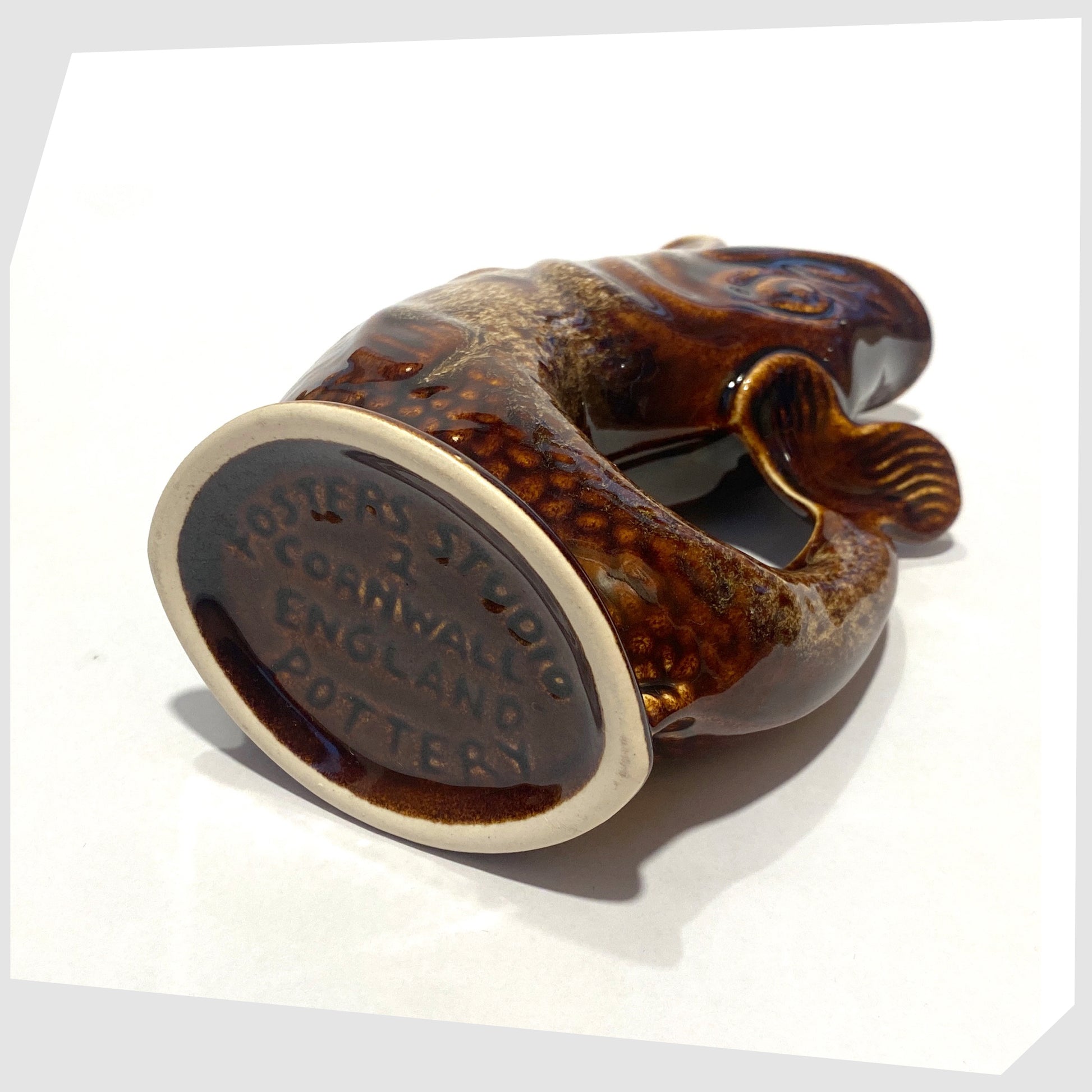 base of the vintage fosters studio pottery fish-shaped gluggle jug in chestnut brown drip glaze