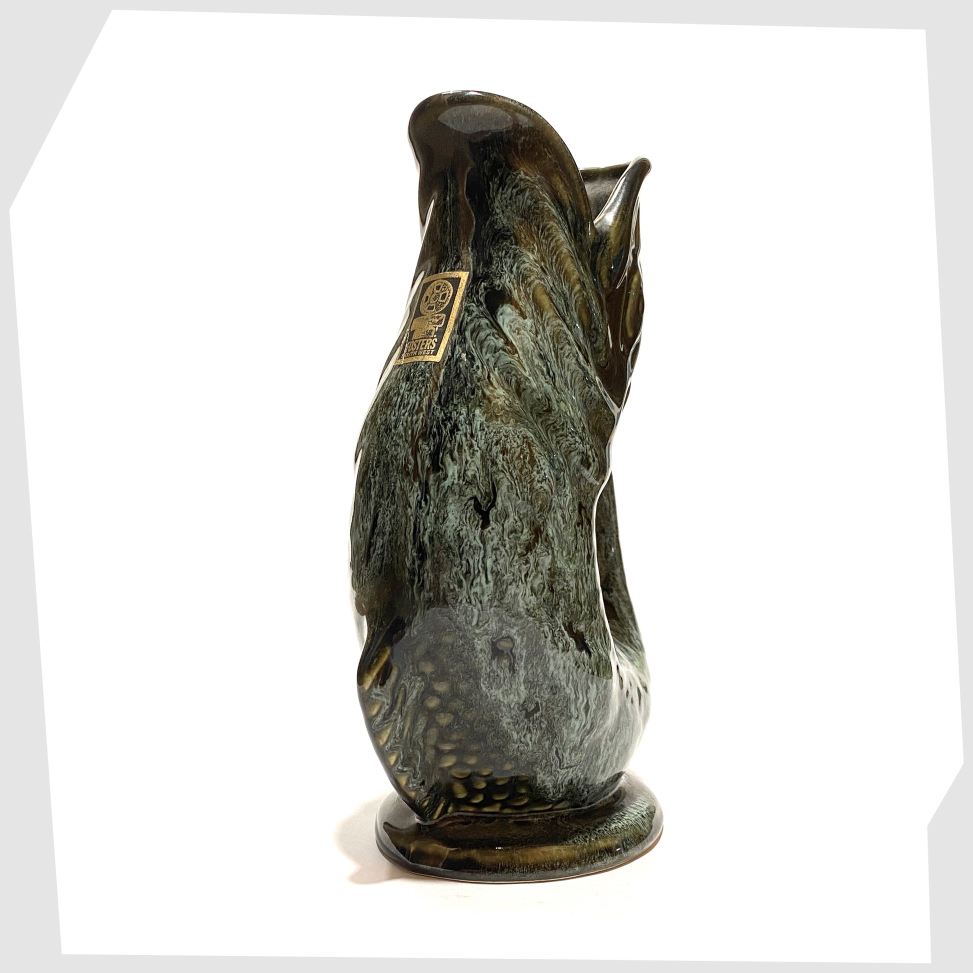 front of the vintage fosters studio pottery gluggle jug in green drip glaze