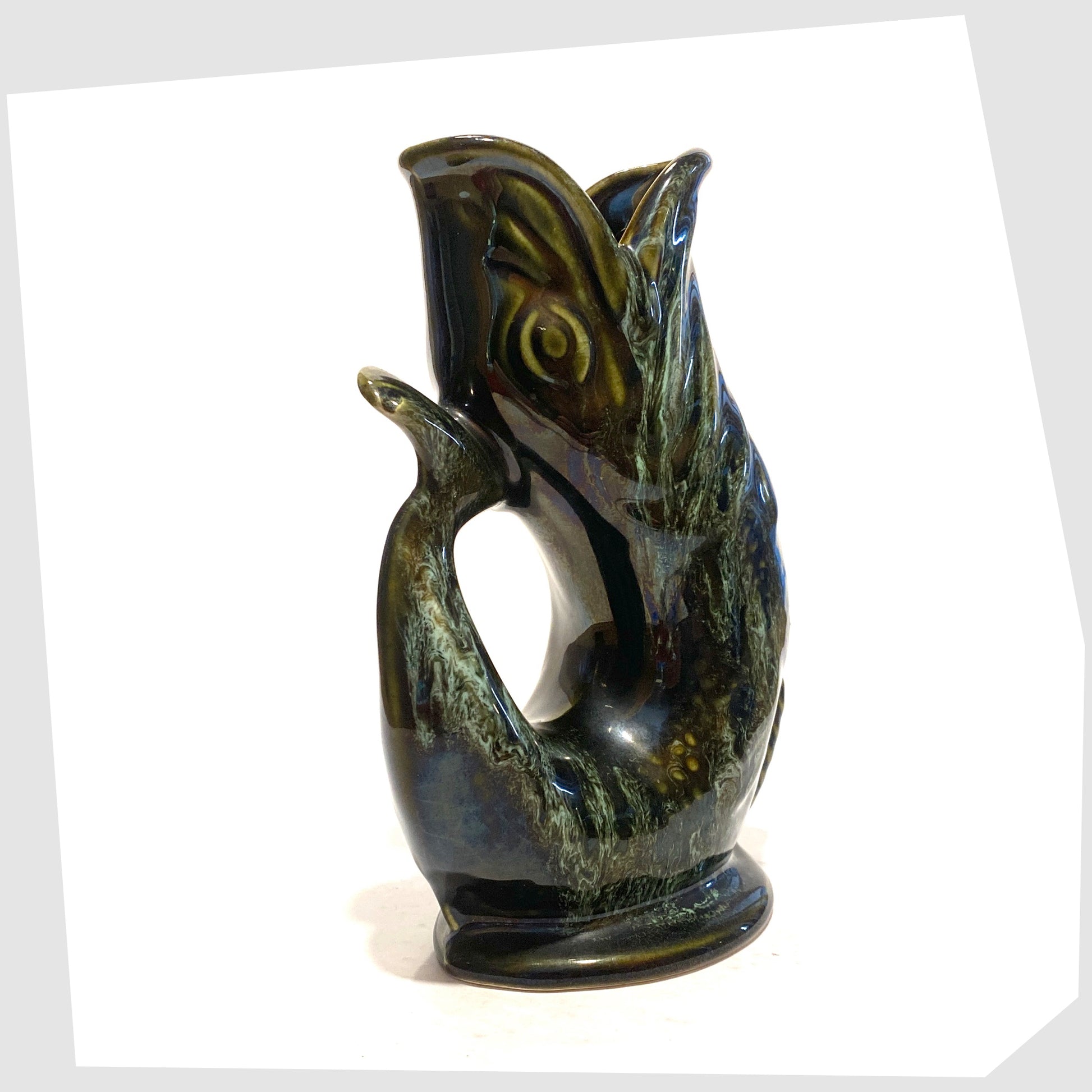 tail/handle of the vintage fosters studio pottery gluggle jug in green drip glaze