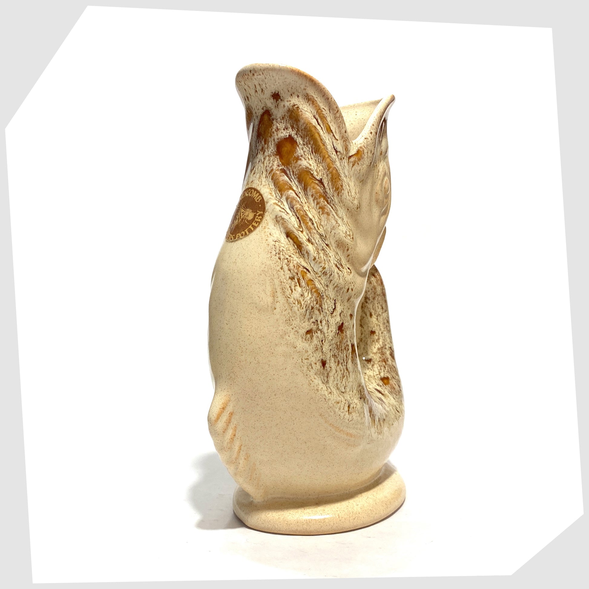 Front of the Fosters Studio Pottery Gluggle Jug in Honeycomb drip glaze with original sticker attached, shown on a white background
