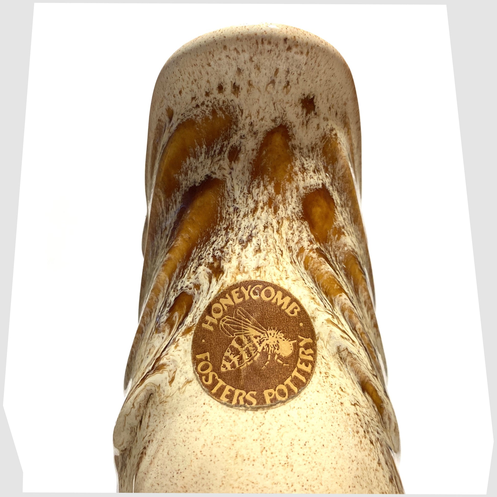 Original sticker attached to the Fosters Studio Pottery Gluggle Jug in Honeycomb drip glaze, shown on a white background