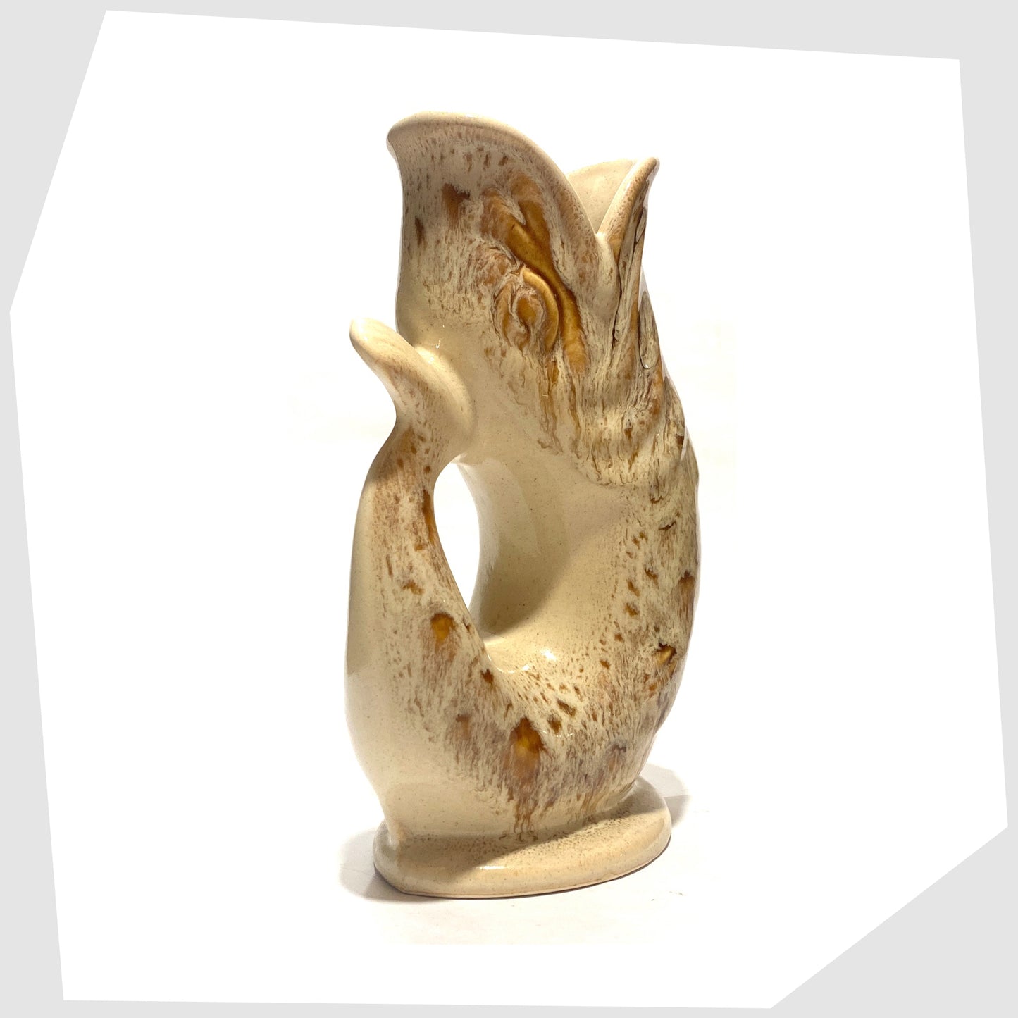 rear tail of the vintage Fosters Studio Pottery Gluggle Jug in a beige and amber honeycomb drip glaze