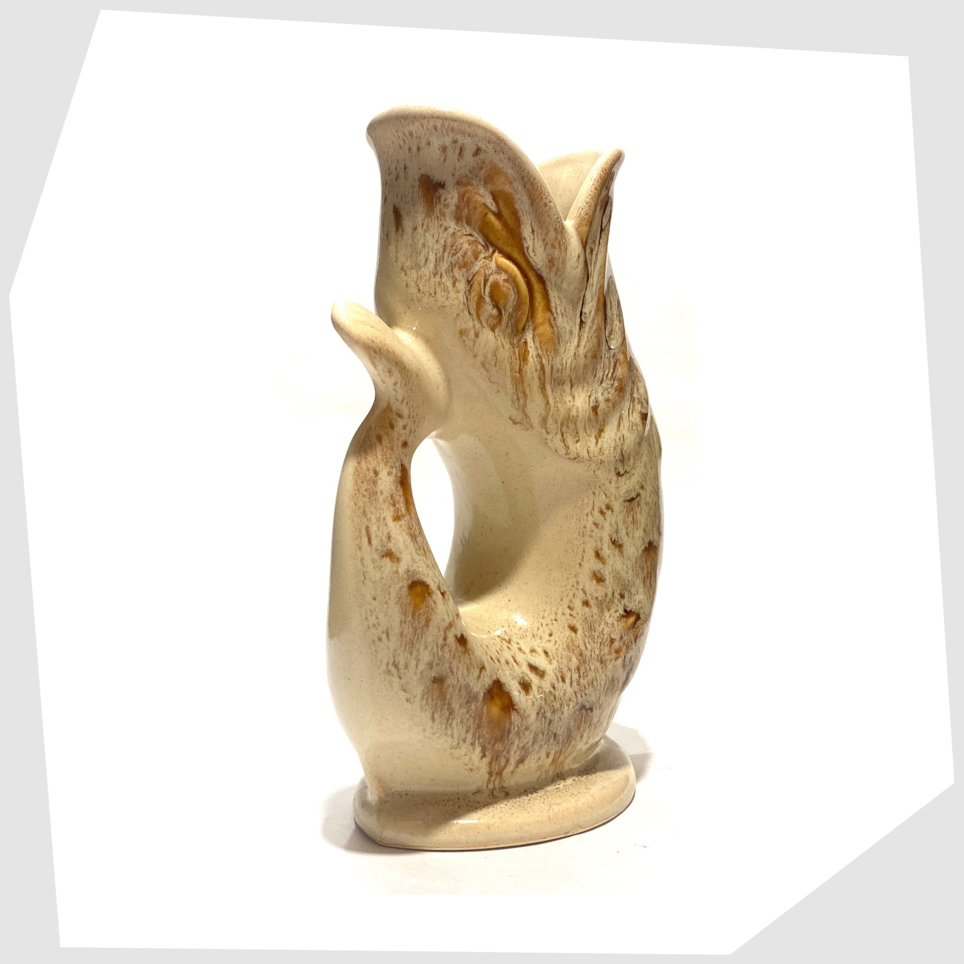 rear tail of the vintage Fosters Studio Pottery Gluggle Jug in a beige and amber honeycomb drip glaze