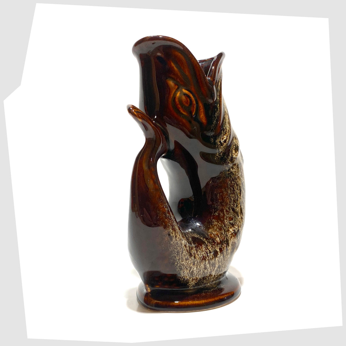 Tail of the Fosters Studio Pottery Gluggle Jug in a chestnut brown with amber drip glaze, shown on a white background