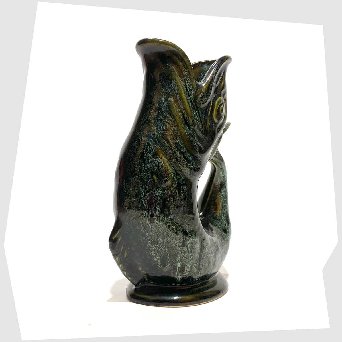 Front of the Fosters Studio Pottery Gluggle Jug in green drip glaze, shown on a white background