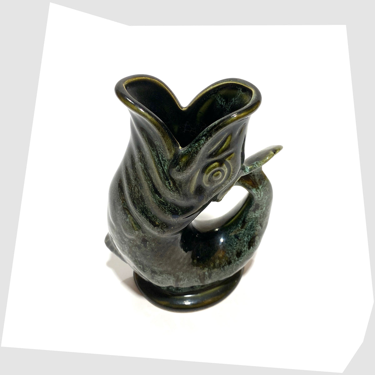 Spout of the vintage Fosters Studio Pottery Gluggle Jug in green drip glaze, shown on a white background