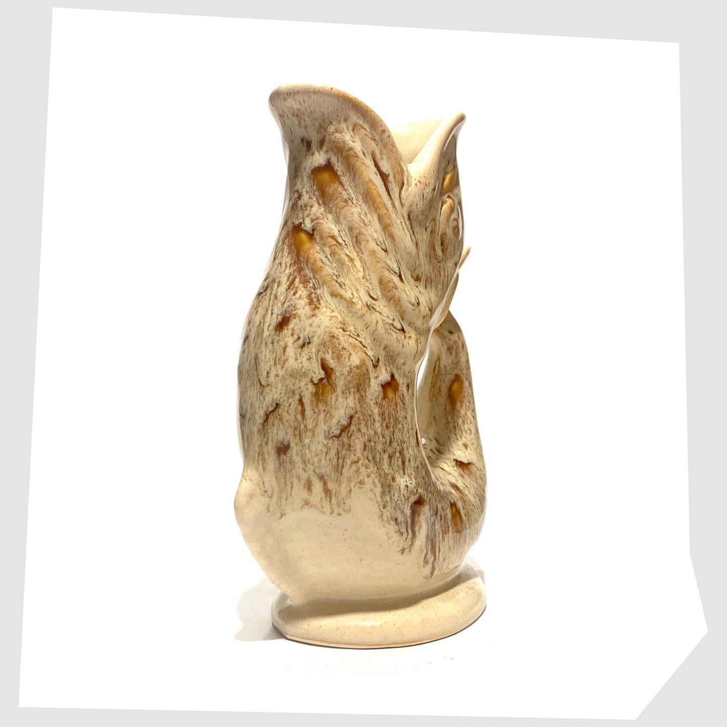 front of the vintage Fosters Studio Pottery Gluggle Jug in a beige and amber honeycomb drip glaze