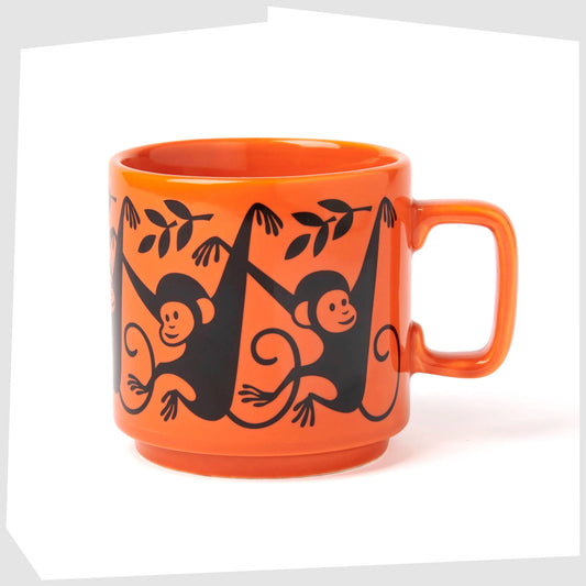magpie x hornsea pottery monkey mug, orange stoneware mug featuring a black print of a swinging monkey