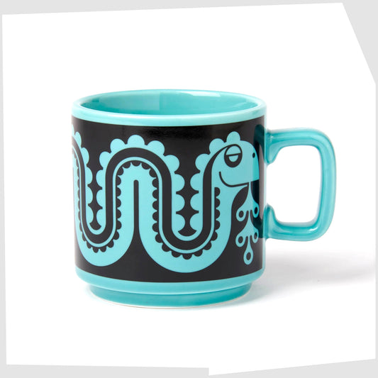 magpie x hornsea pottery nessie mug, blue stoneware mug with a black pattern of a flowing sea monster