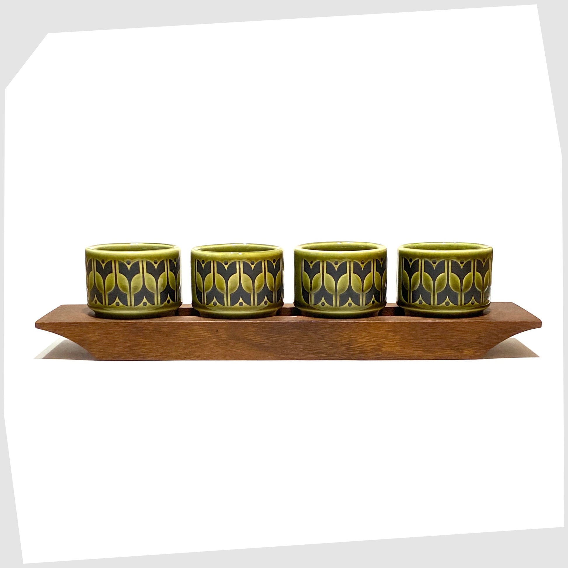 original hornsea pottery egg cup set in the lakeland green heirloom pattern, shown in their wooden display stand