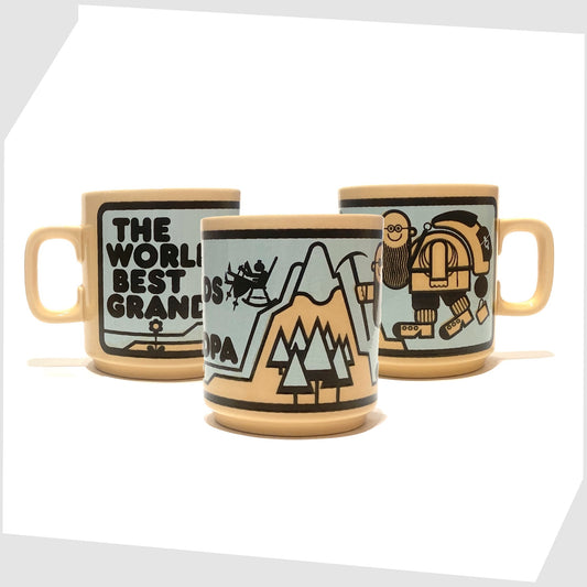 vintage hornsea pottery mug featuring a wrap around illustration of a grandfather climbing a mountain alongside the text 'the worlds best grandpa'
