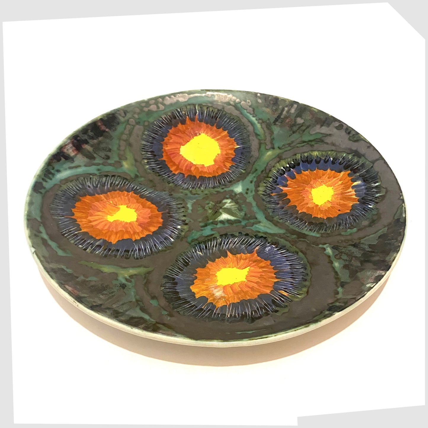 vintage iden pottery charger plate by dennis townsend with gloss circles of red and yellow, framed in a sea green and matte black glaze